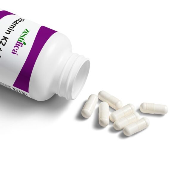 Close-up image showing capsules of Zestifica Vitamin K2 + D3 supplement spilled from bottle